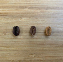 Load image into Gallery viewer, Organic Premium Coffee beans for reference. Dark Roast, medium roast, and light roast options are shown.
